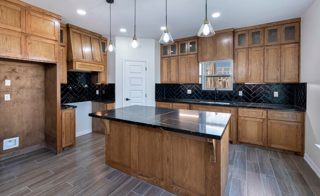 A stylish kitchen with wooden cabinetry and black countertops, showcasing a contemporary aesthetic for home value enhancement.