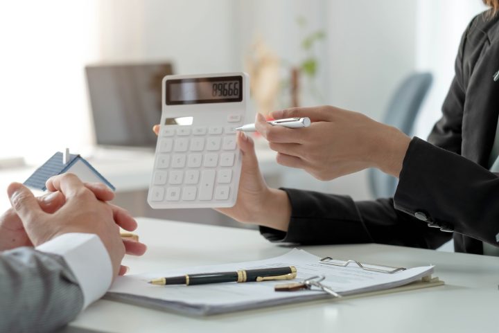 Real estate agent talked about the terms of the home purchase agreement and asked the customer to sign the documents to make the contract legally, Home sales and home insurance concept.