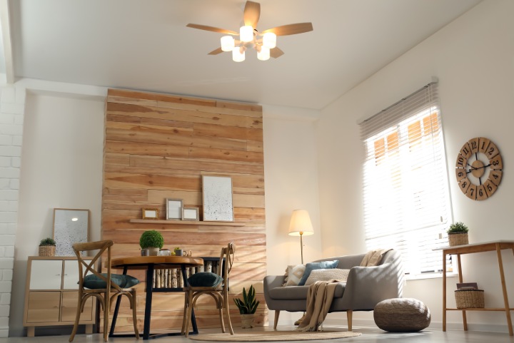 Stylish living room interior with modern ceiling fan, low angle view