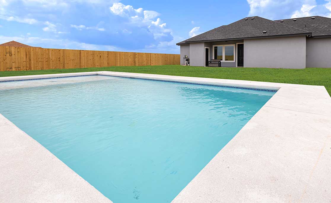 A backyard pool surrounded by a fence and grass, showcasing ideas for outdoor living spaces in Texas.