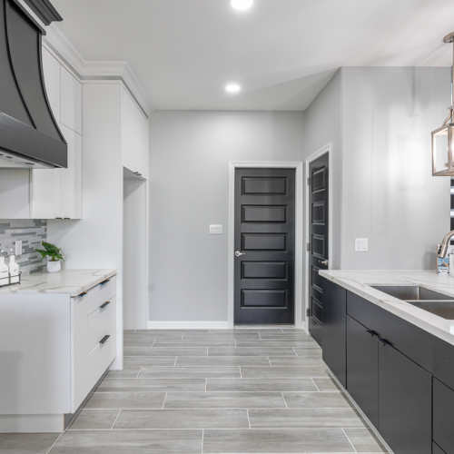 Modern kitchen featuring sleek cabinetry, stylish backsplash, and elegant lighting fixtures.